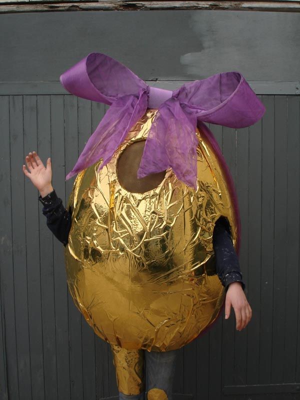 Person in gold Easter Egg costume, with holes for arms and legs.